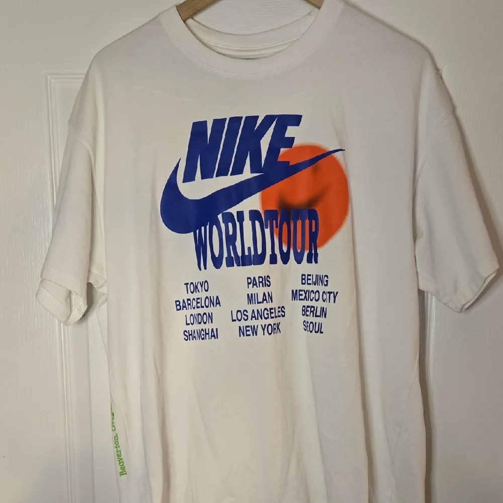 Nike World Tour White T-Shirt with Blue and Orange‎ Graphics